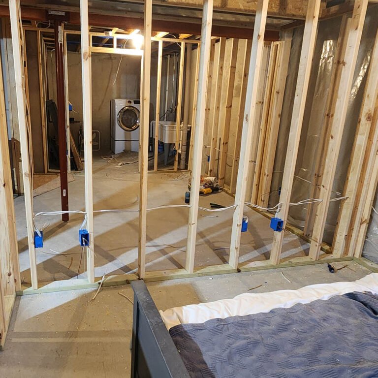 Residential basement electrical wires running between wall studs